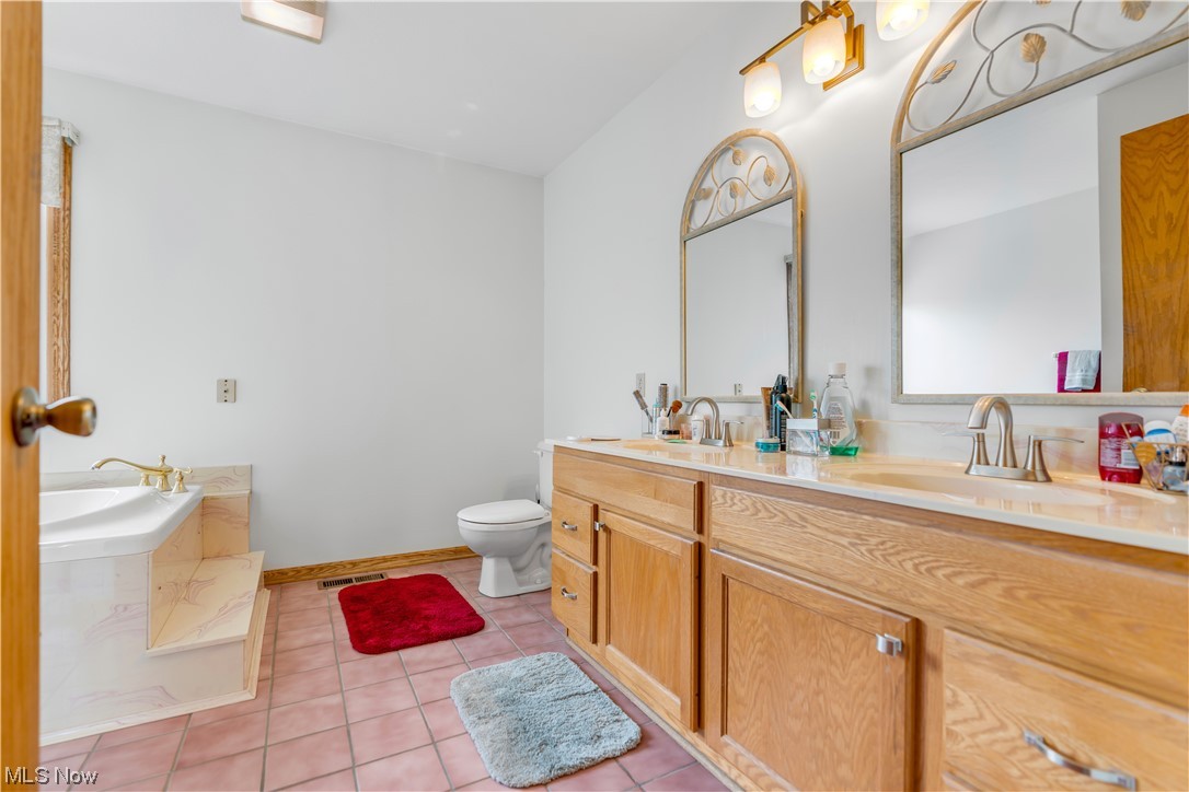 2652 Woodview Road Uniontown, OH 44685 - Photo 23 of 35 Here is a view of the owners bathroom. Complete with dual vanities, large tub and shower.