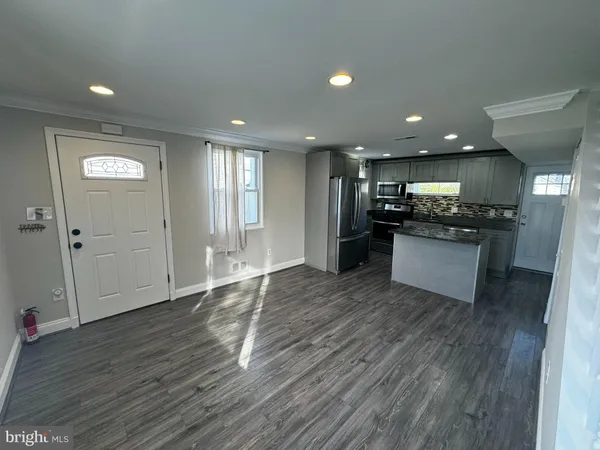 a kitchen with stainless steel appliances granite countertop a refrigerator and a stove top oven