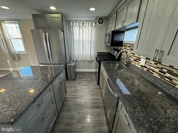 a kitchen with refrigerator and window
