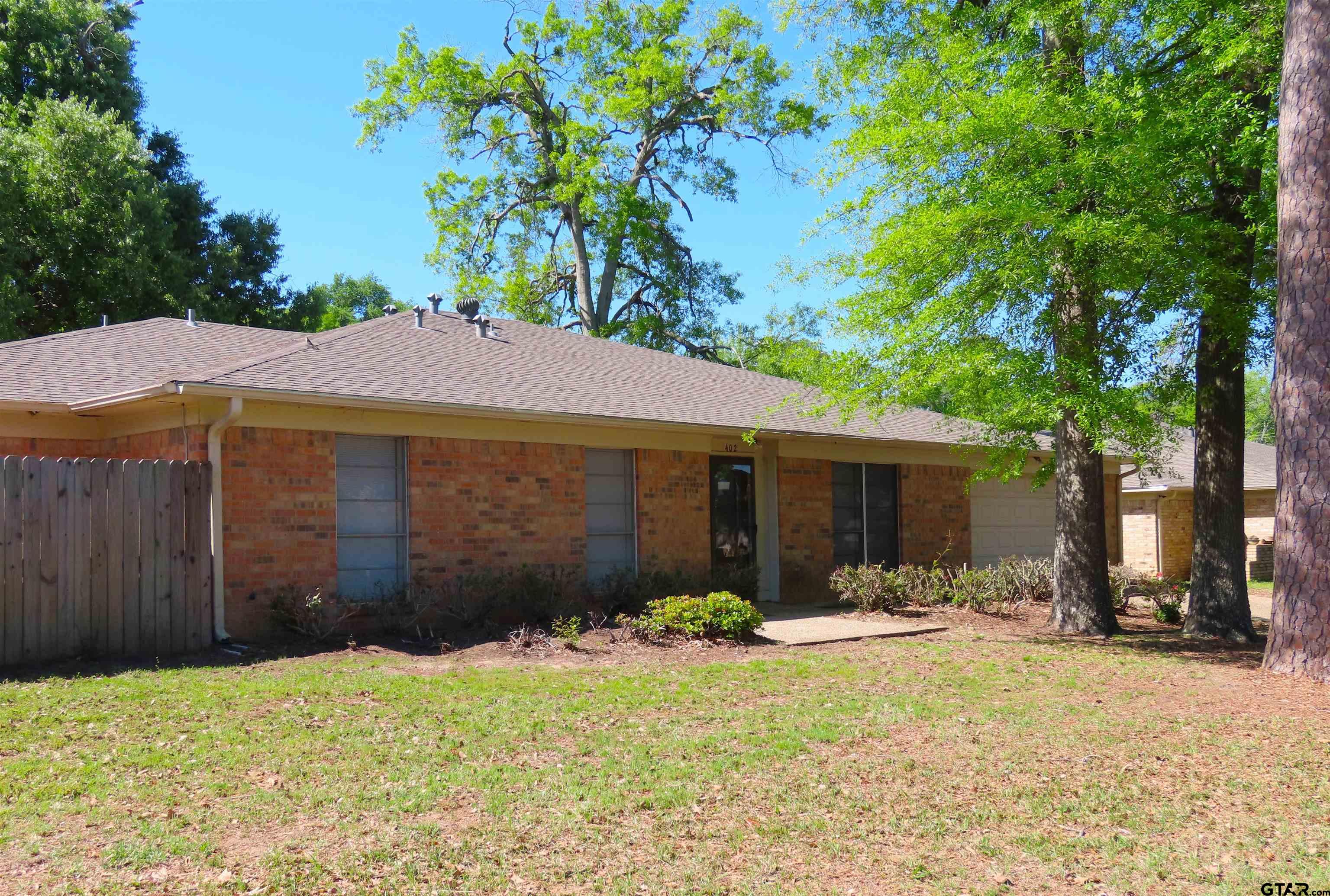402 Muller Garden Road Tyler, TX 75703 - Photo 2 of 33 a backyard of a house with yard and outdoor seating