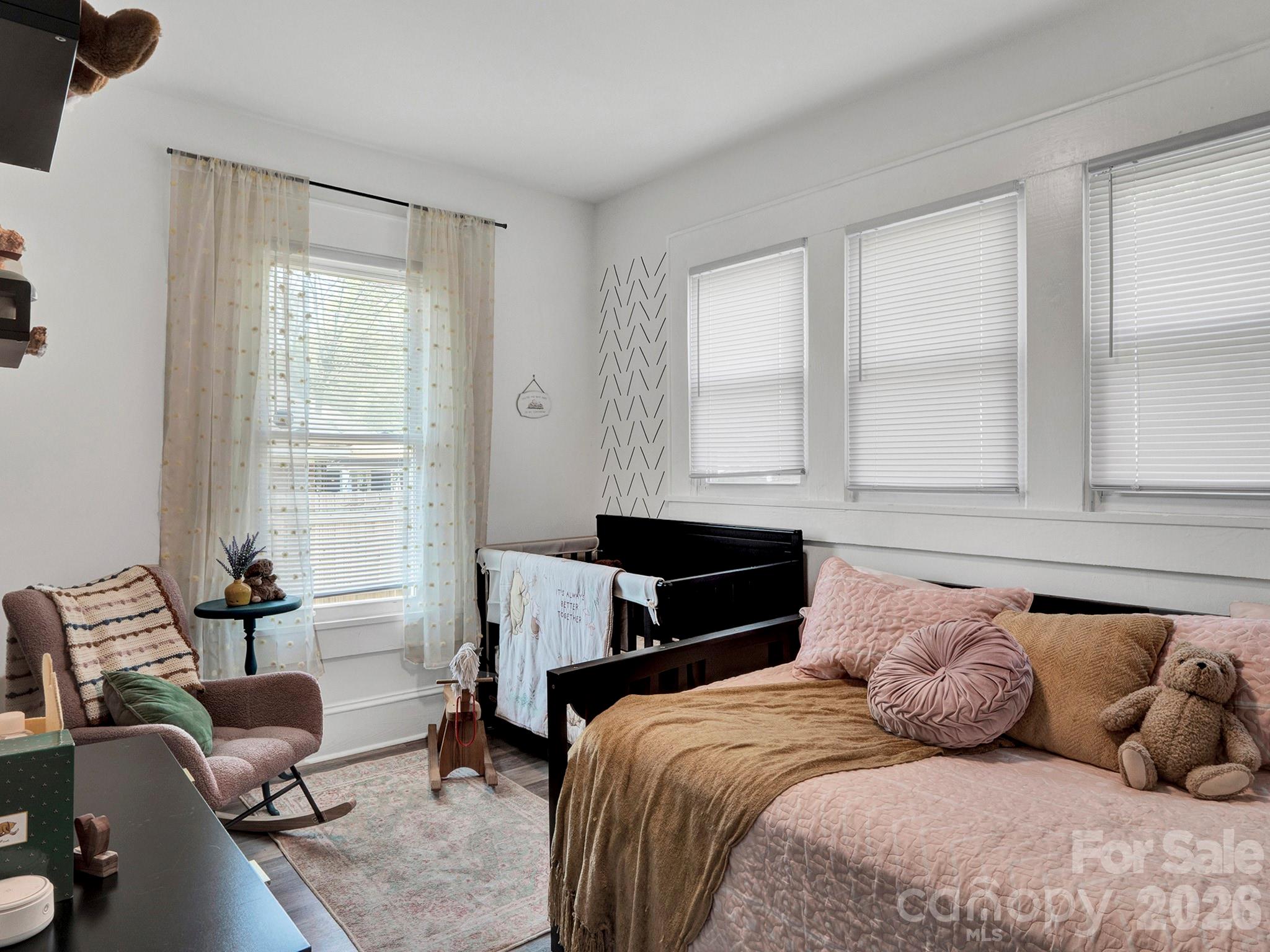 208 Hough Street Monroe, NC 28112 - Photo 22 of 32 a bedroom with a bed and wooden floor