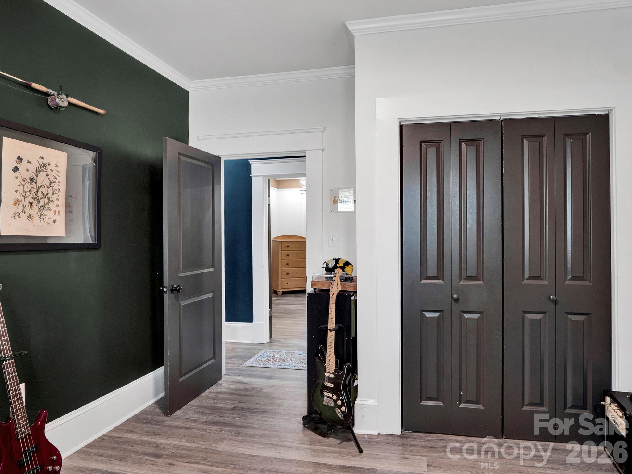 208 Hough Street Monroe, NC 28112 - Photo 25 of 32 a view of a hallway with wooden floor and staircase