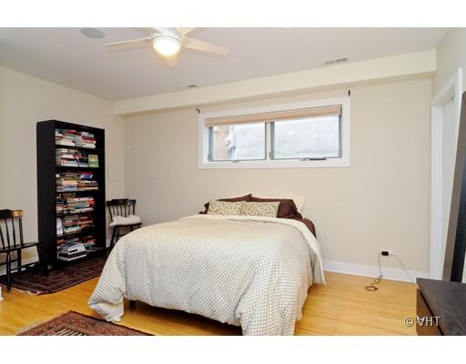 950 West Cullerton Street, Unit A Chicago, IL 60608 - Photo 6 of 12 a bedroom with a bed a dresser and book shelf