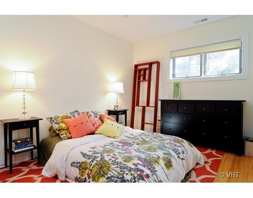 950 West Cullerton Street, Unit A Chicago, IL 60608 - Photo 8 of 12 a bedroom with a bed and a lamp on dresser