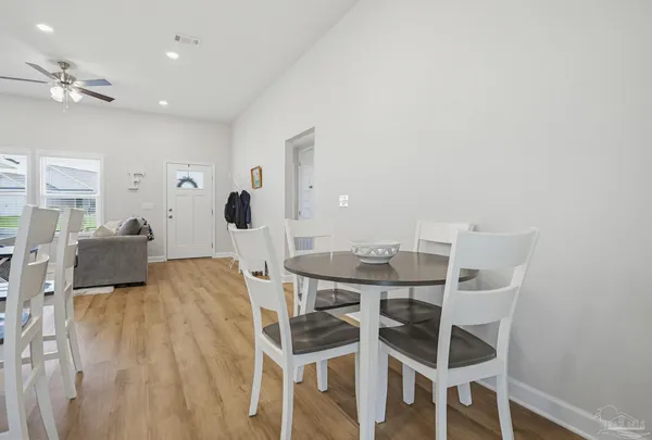 a view of a dining room with furniture and wooden floor