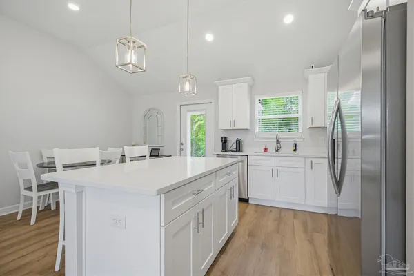a large white kitchen with a large window