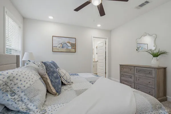 a bedroom with a bed and a dresser