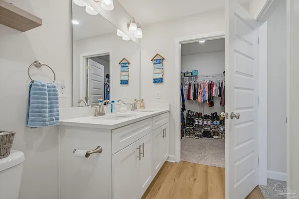 a en suite bathroom with a sink double vanity and a mirror