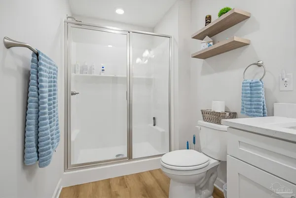a bathroom with a shower a toilet and sink