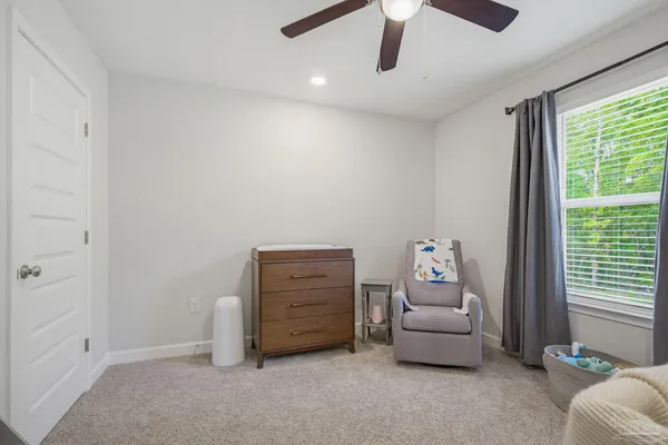 a view of room with baby crib and cabinet