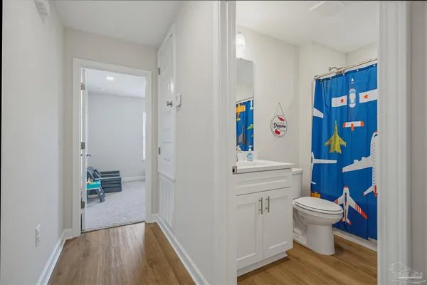 a bathroom with a toilet sink and mirror