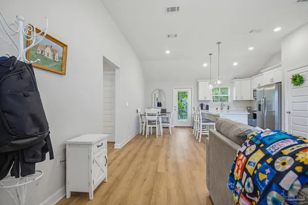 a living room with furniture and a wooden floor