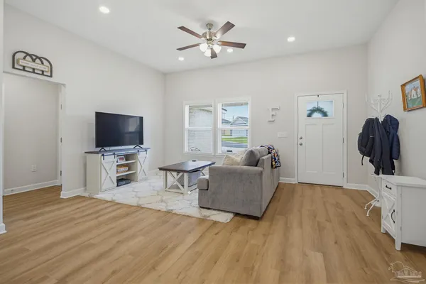 a living room with furniture and a flat screen tv