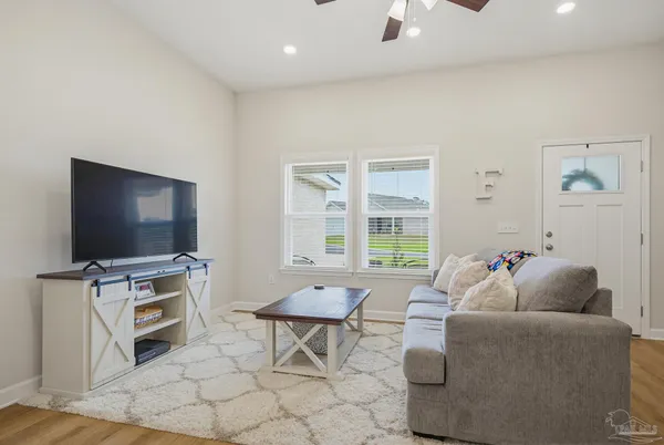 a living room with furniture and a flat screen tv