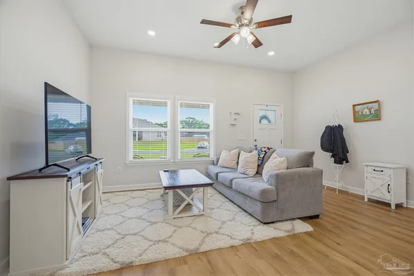 a living room with furniture and a flat screen tv