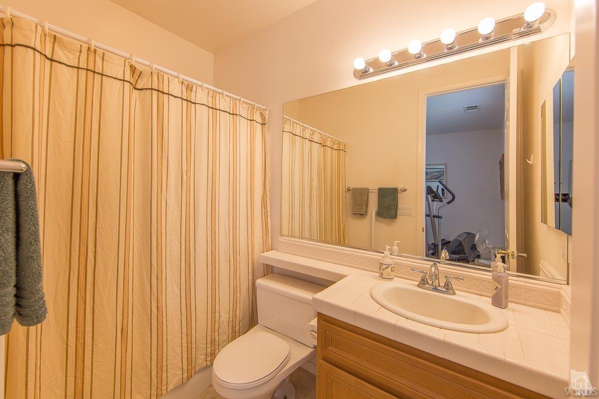1487 Hidden Ranch Drive Simi Valley, CA 93063 - Photo 8 of 28 a bathroom with a sink a toilet and mirror