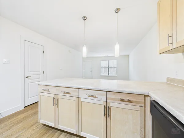 a kitchen with white cabinets and white appliances