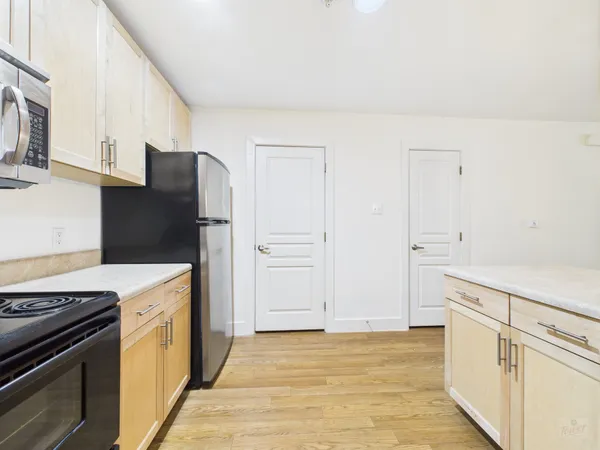 a kitchen with a stove and a refrigerator