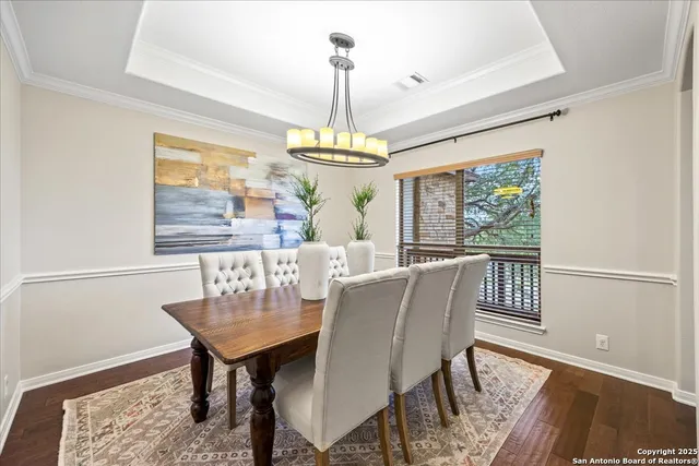 a living room with furniture large window and wooden floor