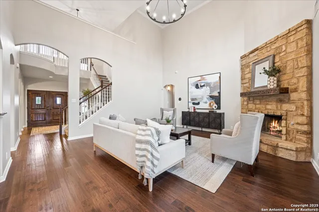 a living room with couches fireplace and a fireplace