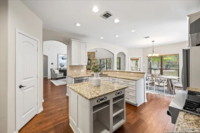 a kitchen with a stove and cabinets