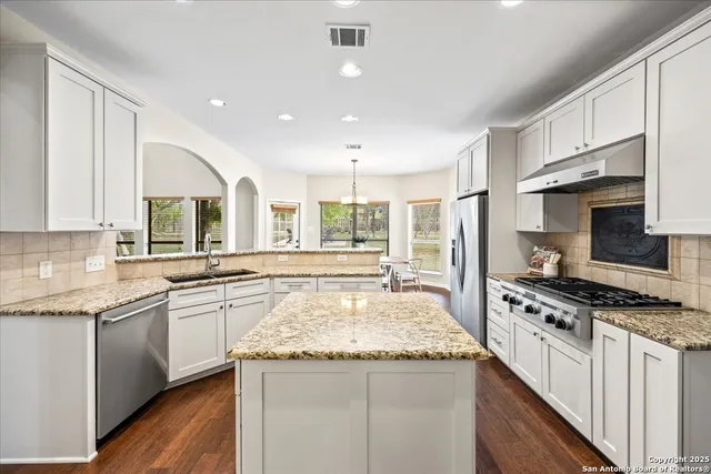 a spacious bedroom with a bed and a couch