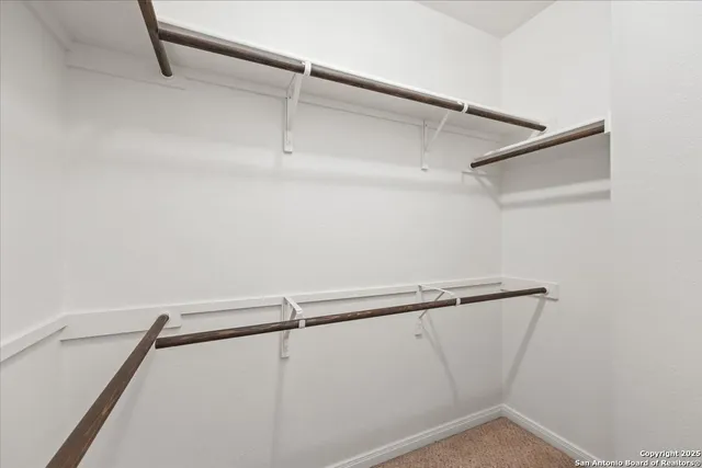 a spacious bathroom with 2 sink tub and a mirror