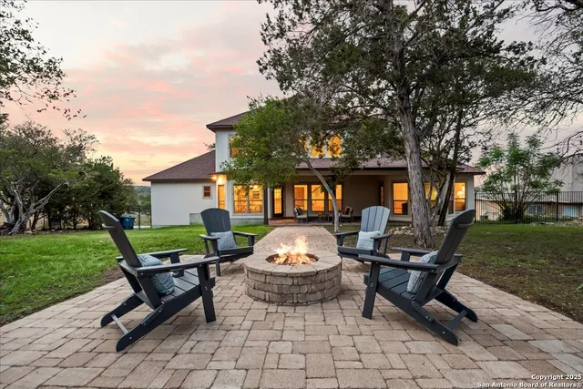 an aerial view of residential houses with outdoor space and trees