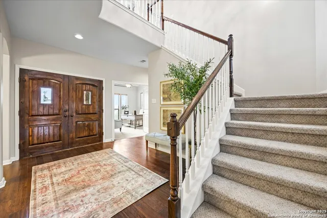 a view of entryway with wooden floor and stairs