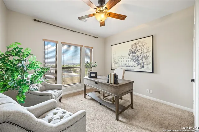 an empty room with a window and a fan