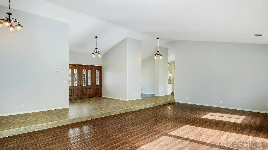 14525 Millards Ranch Lane Poway, CA 92064 - Photo 6 of 29 a view of an empty room with window and wooden floor