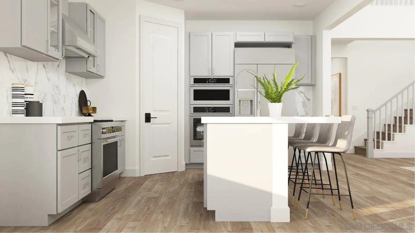 17431 Abbey Road Poway, CA 92064 - Photo 3 of 30 a kitchen with stainless steel appliances a refrigerator a stove a sink and a dining table with wooden floor