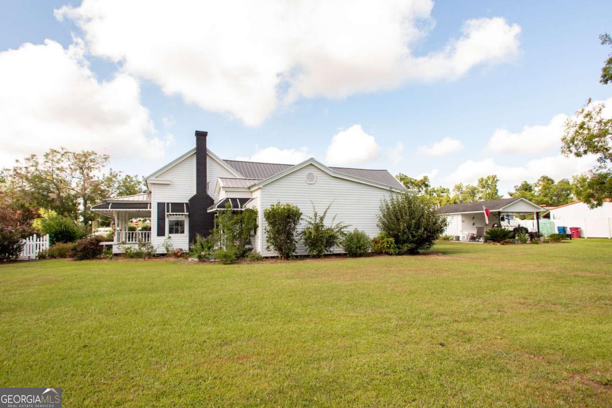 43 Graham Methodist Church Road Hazlehurst, GA 31539 - Photo 11 of 54 a front view of a house with a yard and lake view