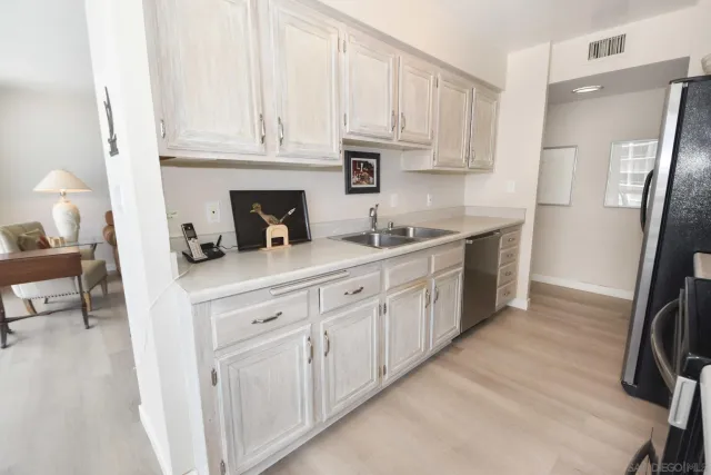a kitchen with white cabinets and a sink