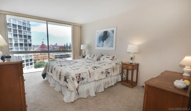 a spacious bedroom with a bed and a large window