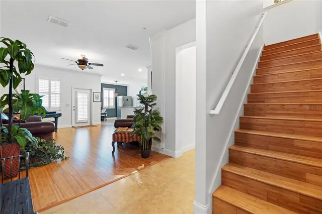 a view of an empty room with wooden floor