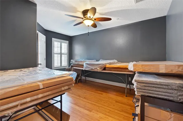a bedroom with a bed and a dresser next to a window