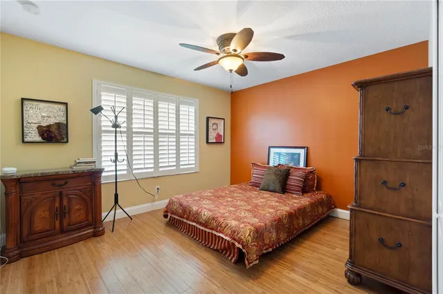 a bathroom with a granite countertop sink a toilet and shower