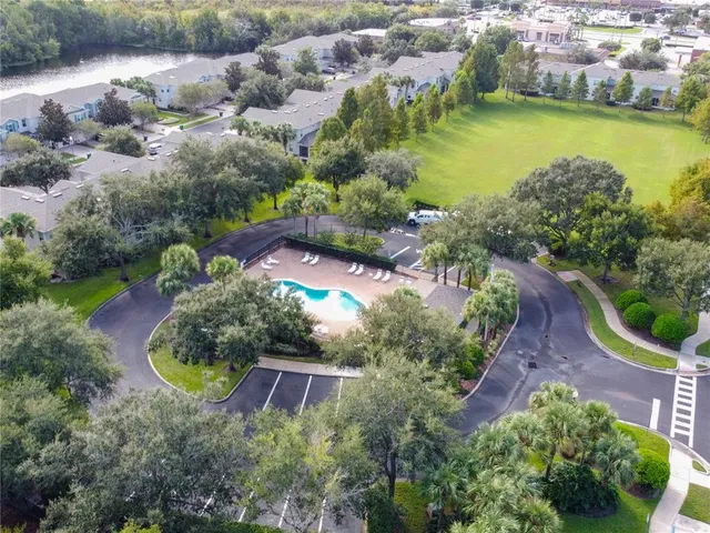 an aerial view of a house with a swimming pool yard and outdoor seating