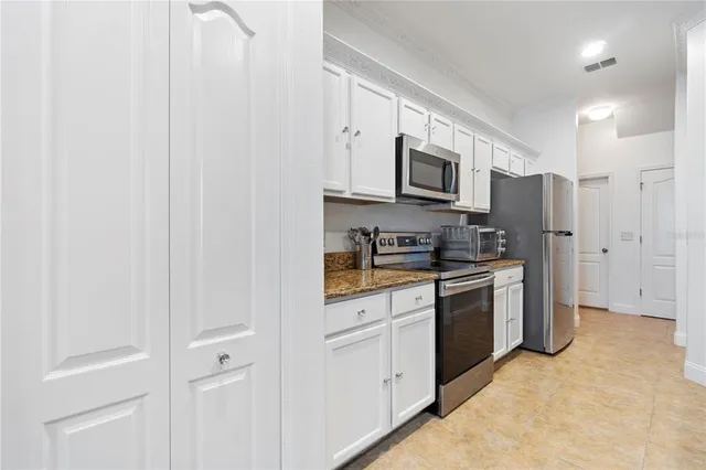 a kitchen with stainless steel appliances granite countertop a stove and a microwave