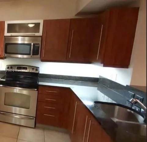 a kitchen with a sink and a stove top oven