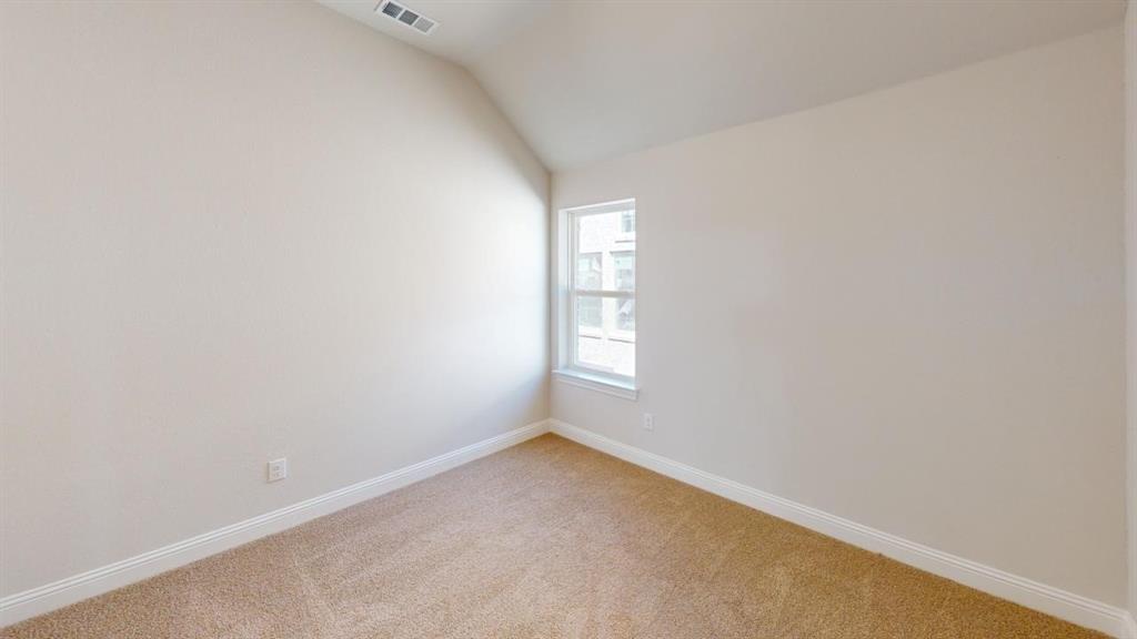 8407 Cornerstone Drive Rowlett, TX 75088 - Photo 13 of 25 Carpeted room featuring a single window with white trim, a sloped ceiling, light-toned wall paint, and white baseboards