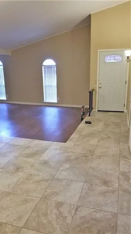 a view of a room with wooden floor