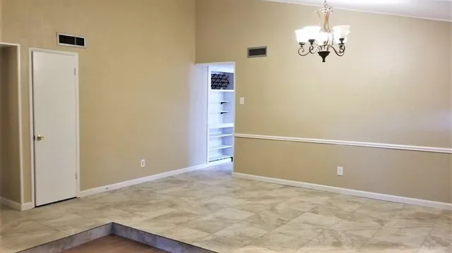 a view of a chandelier in an empty room