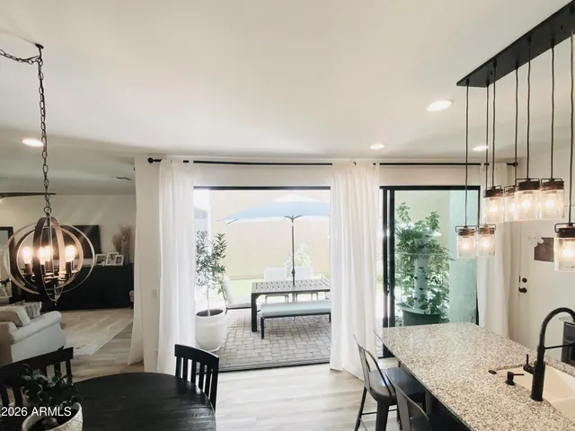 a living room with a table and chairs