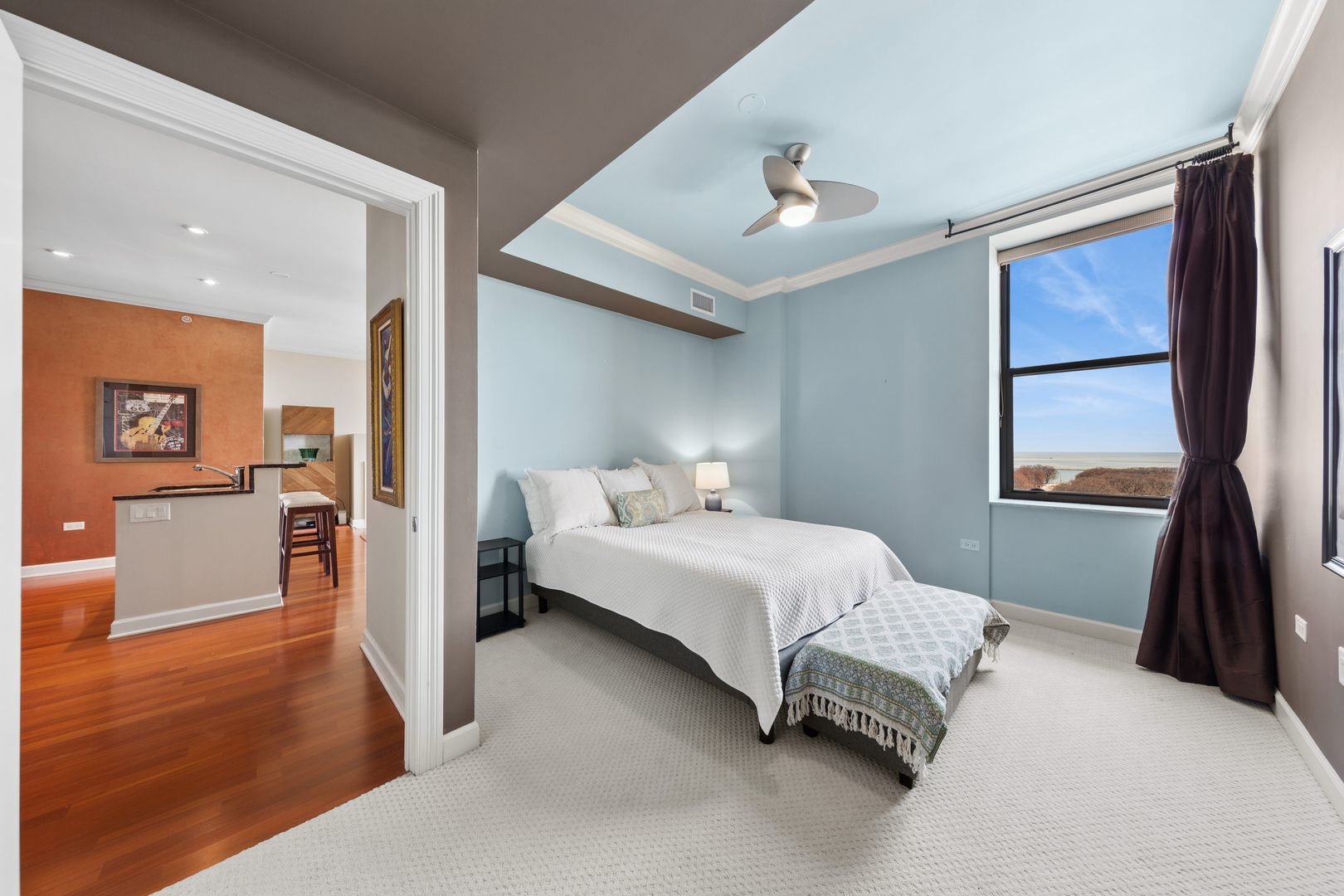 310 South Michigan Avenue, Unit 1001 Chicago, IL 60604 - Photo 14 of 40 a bedroom with a bed and a large mirror
