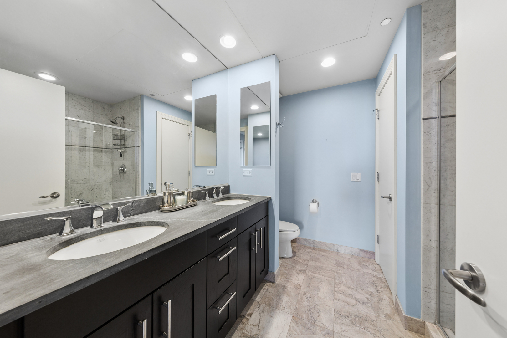 310 South Michigan Avenue, Unit 1001 Chicago, IL 60604 - Photo 16 of 40 a bathroom with a double vanity sink and mirror with shower