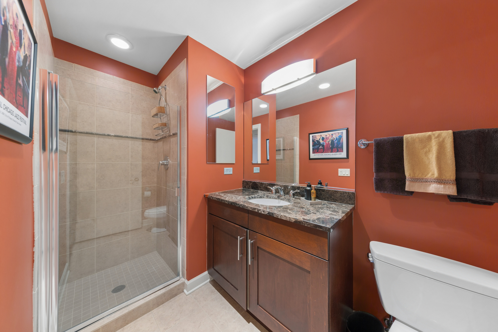 310 South Michigan Avenue, Unit 1001 Chicago, IL 60604 - Photo 18 of 40 a bathroom with a granite countertop sink a toilet a mirror and shower