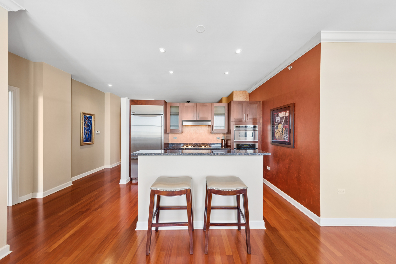 310 South Michigan Avenue, Unit 1001 Chicago, IL 60604 - Photo 6 of 40 a kitchen with stainless steel appliances granite countertop a refrigerator a stove top oven and wooden floor