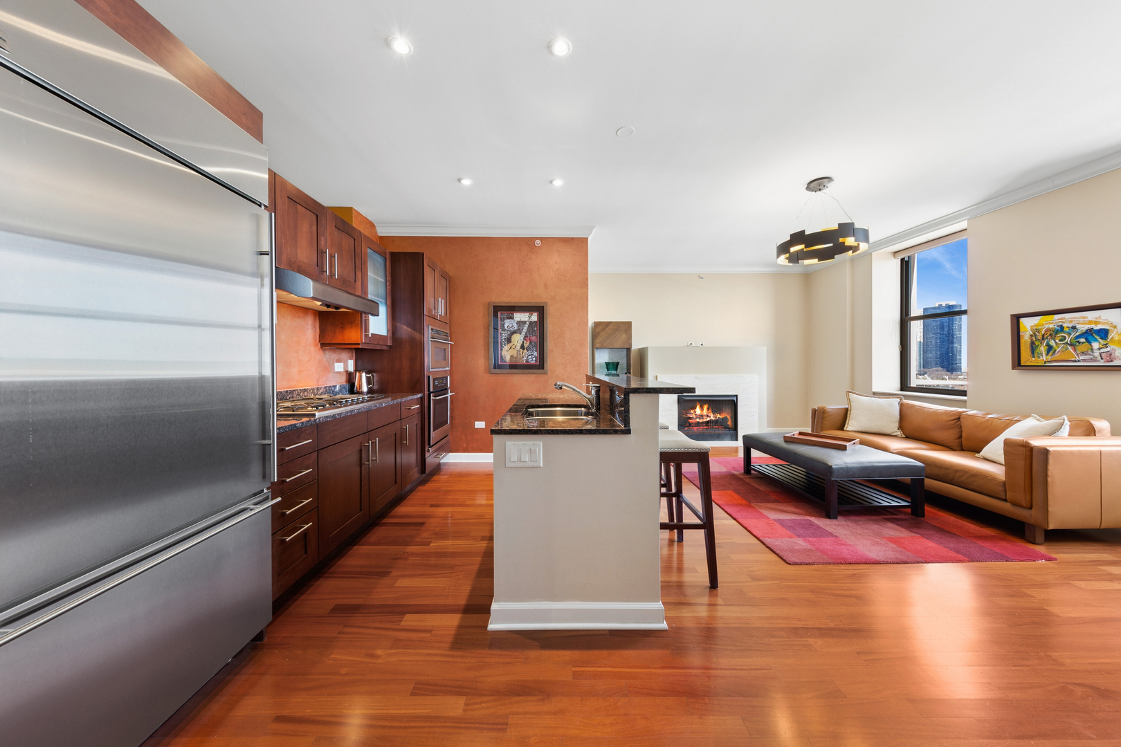 310 South Michigan Avenue, Unit 1001 Chicago, IL 60604 - Photo 10 of 40 a living room with lots of furniture and kitchen view